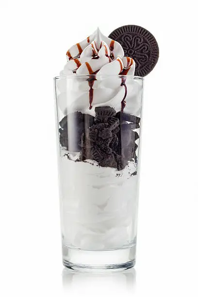tasty vanilla frozen yogurt with chocolate cookies and whipped cream