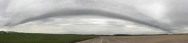 A panoramic image shows a weather front over a major UK airport.