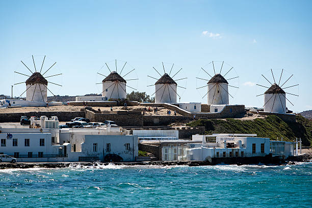 istock Five windmills on Mykonos with sea in foreground 623928884