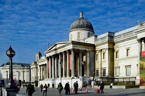 London, United Kingdom - January 19, 2016: Unidentified people and National Gallery on Trafalgar square