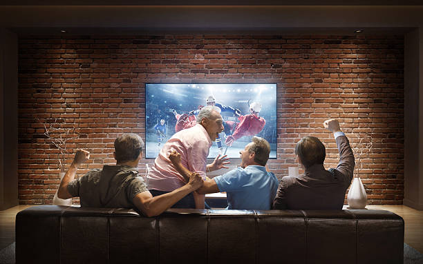 istock Adults watching Ice Hockey game at home 623930476