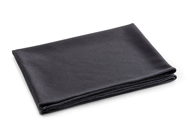 Folded black cotton napkin isolated on white background