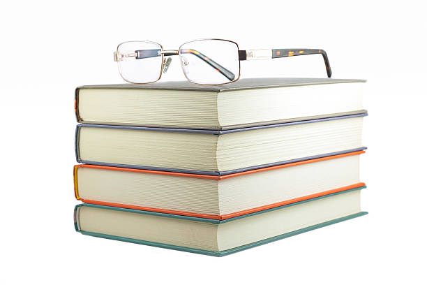 istock books with glasses on a white background 623937878