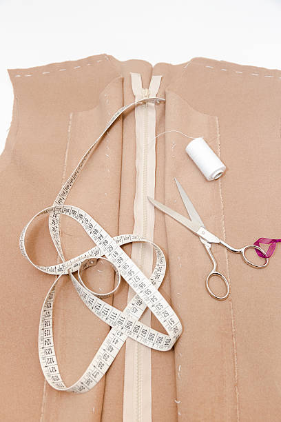 istock Dressmaker prepares wrap detail with sketch lines. 623938904