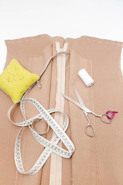 istock Dressmaker prepares wrap detail with sketch lines. 623938962