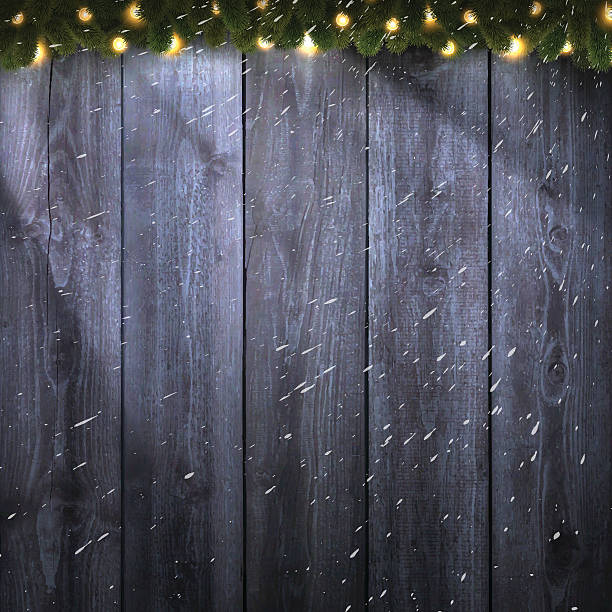 istock Light on blank wooden background with bright garland and snow 623940288