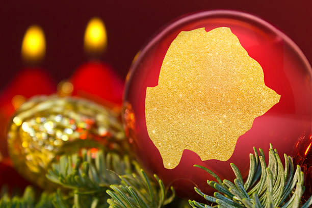 istock Red bauble with the golden shape of Botswana.(series) 623940584