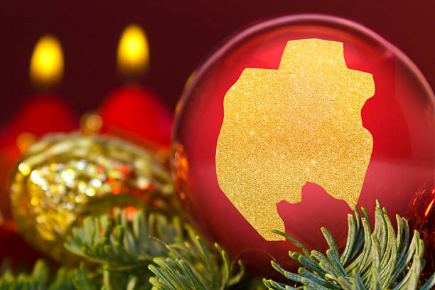 istock Red bauble with the golden shape of Gabon.(series) 623941654