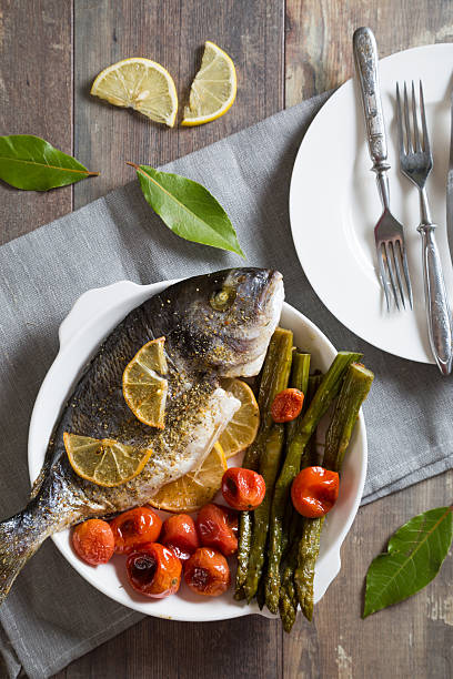 istock Baked fish with asparagus and cherry tomatoes 623942108