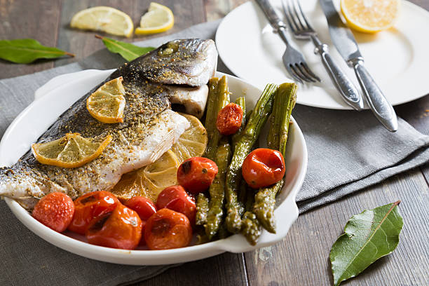 istock Baked fish with asparagus and cherry tomatoes 623942458
