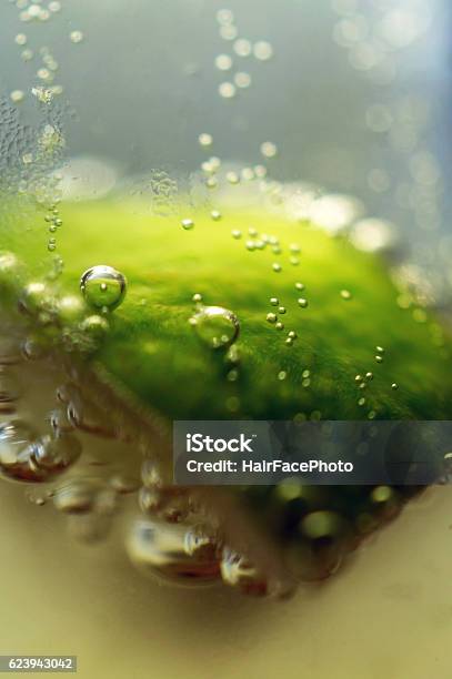 Macro Detail Of Bubbles Coming Off Lime In Beer Stock Photo - Download Image Now - Alcohol - Drink, Beer - Alcohol, Bubble