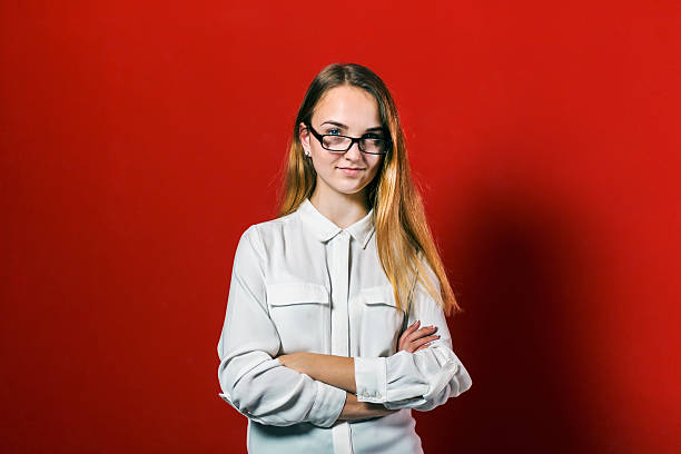 istock Attractive Student Blonde Girl with Glasses on Red 623943344