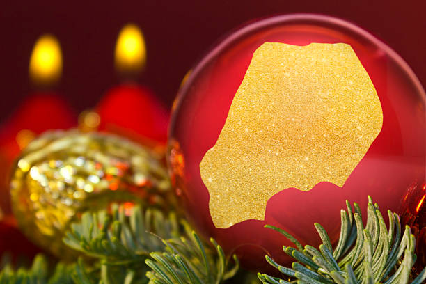 istock Red bauble with the golden shape of Uganda.(series) 623944248