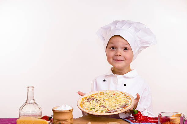 istock boy chef to cook a pizza 623945060