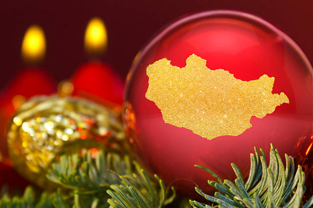istock Red bauble with the golden shape of Mongolia.(series) 623954622