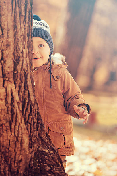 istock Happy child playing in autumn park 623955010