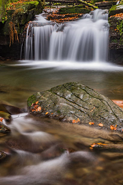 istock Autumn waterfalls with stones 623955012
