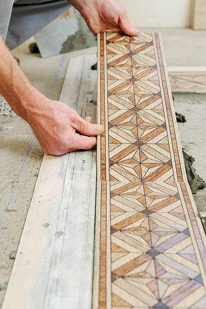 istock Worker putting tiles on the floor. 623964636