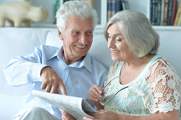 istock Senior couple portrait with newspaper 623965252