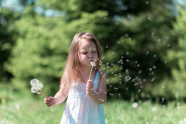 istock Little girl with dandelion 623968586