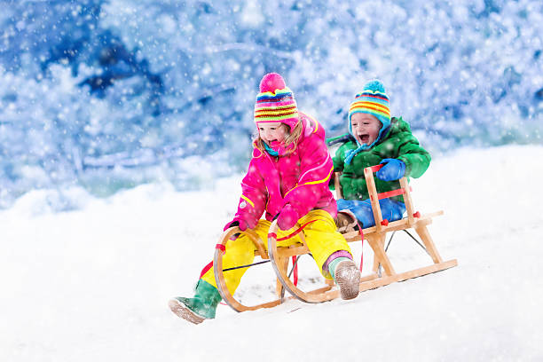 istock Kids having fun on sleigh ride during family Christmas vacation 623980064
