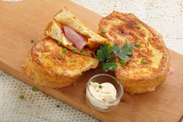 istock Fresh toasts with ham cheese on wooden board 623981032