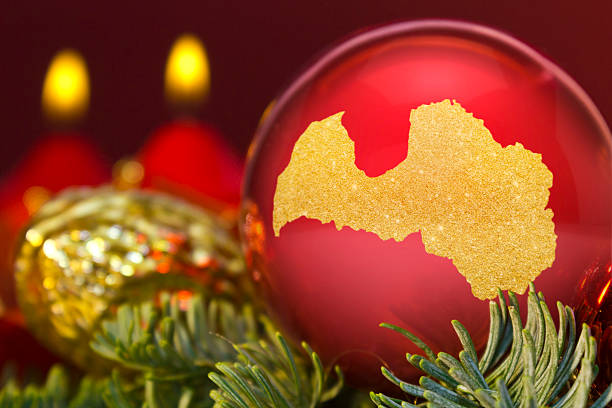istock Red bauble with the golden shape of Latvia.(series) 623981088