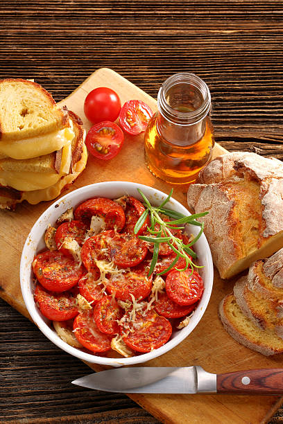 Baked tomatoes, corn bread and sandwiches with melted cheese