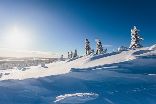 Beautiful cold mountain view of ski resort, sunny winter day with slope, piste and ski lift, Scandinavia, Lapland, blue sky