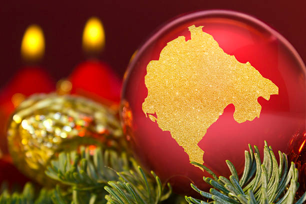 istock Red bauble with the golden shape of Montenegro.(series) 623981732