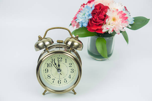 istock Vintage alarm clock and flower vase on white background 623981858