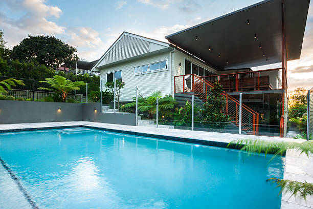 istock Luxury poolside closes up with modern house with green trees 623982666