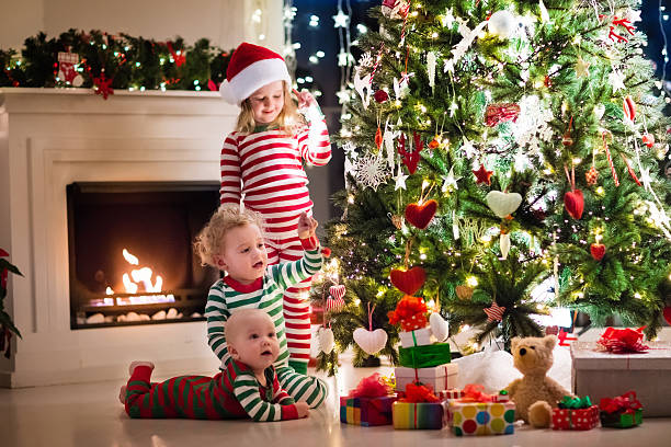 istock Kids in pajamas under Christmas tree on Xmas eve 623982674