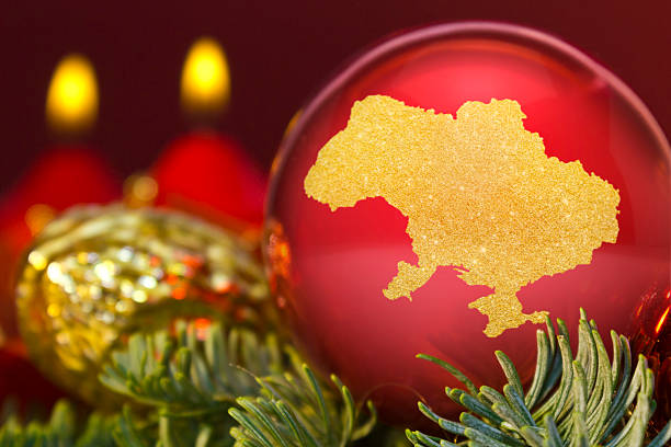 istock Red bauble with the golden shape of Ukraine.(series) 623982880