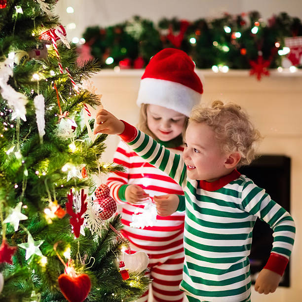 istock Kids in pajamas under Christmas tree on Xmas eve. 623983190