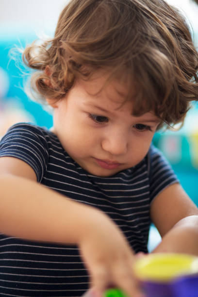 istock Young baby boy playing with his toys 623983272