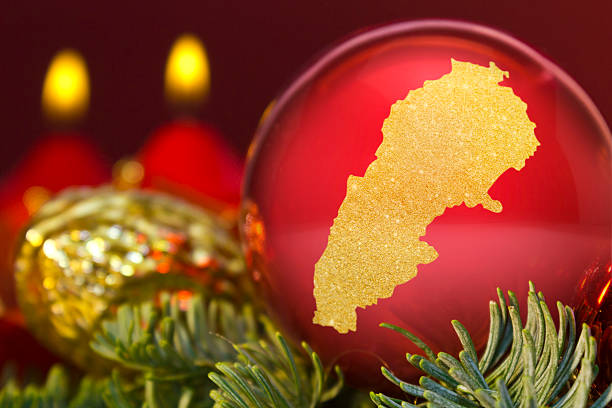 istock Red bauble with the golden shape of Lebanon.(series) 623983592