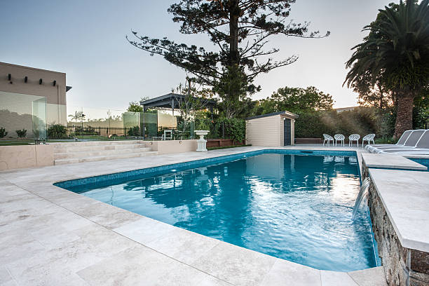 istock Luxury swimming pool view from a corner with trees 623983960