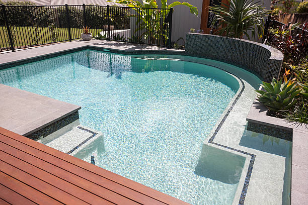 istock Swimming pool water  with spreading sunlight giving waves 623984098