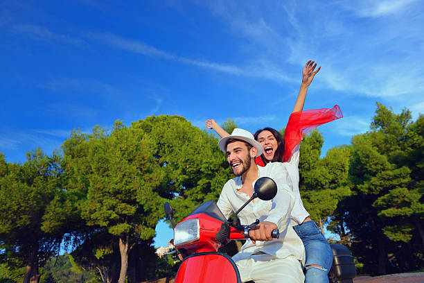 istock Beautiful couple in love enjoying and having fun on scooter 623998422