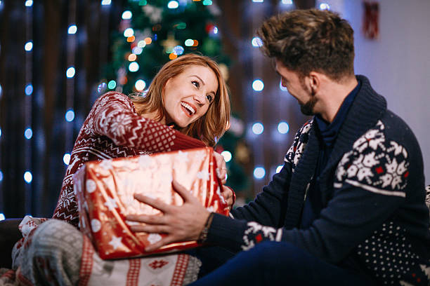 istock Couple opening presents before the tree the night Christmas 624003160