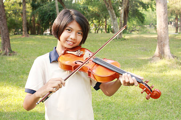 istock Happy young girl playing his violin 624003752