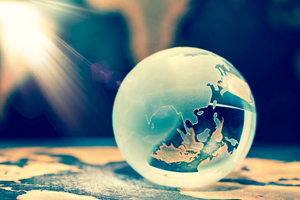 istock Crystal globe on grunge world map, with lens flare 624004754
