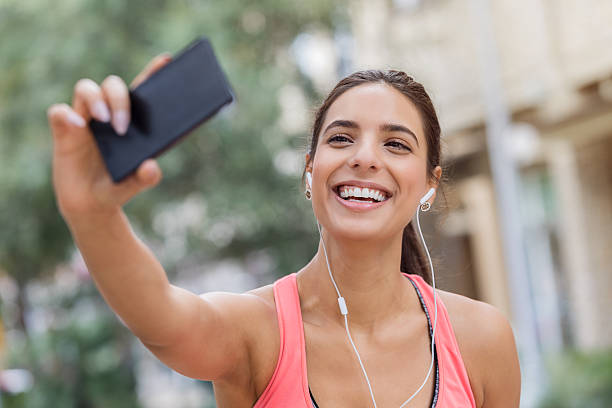 istock Pretty millennial takes selfie before daily run 624005562