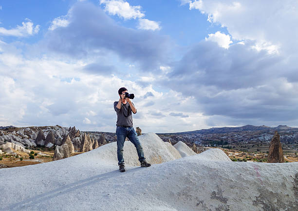 istock young man taking photo in the wild 624006218