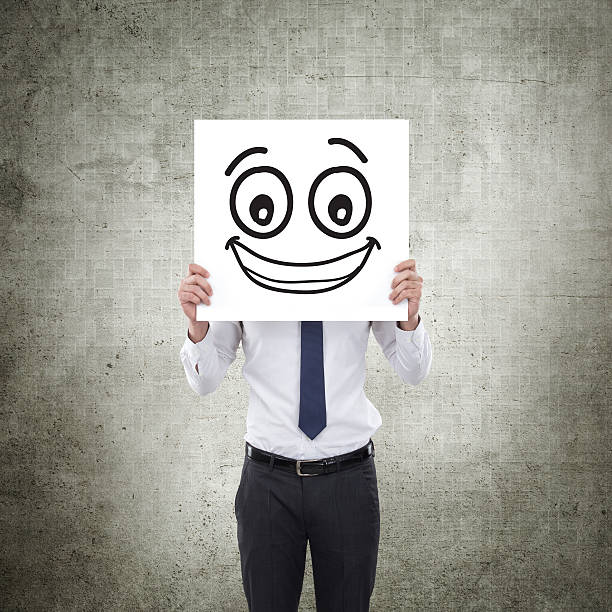 istock Businessman holding white card with emoticon on it 624008248