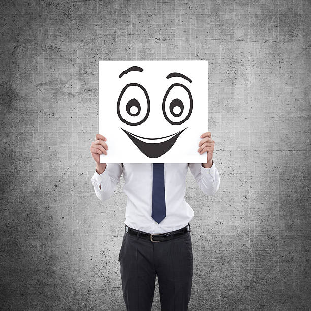 istock Businessman holding white card with emoticon on it 624008322