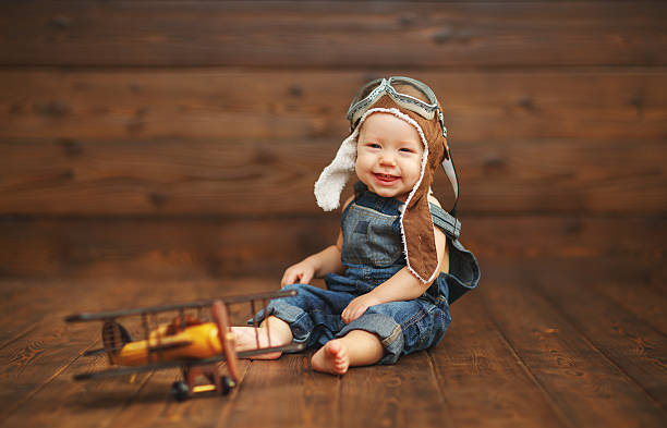 istock funny baby boy pilot aviator with airplane laughing 624008932
