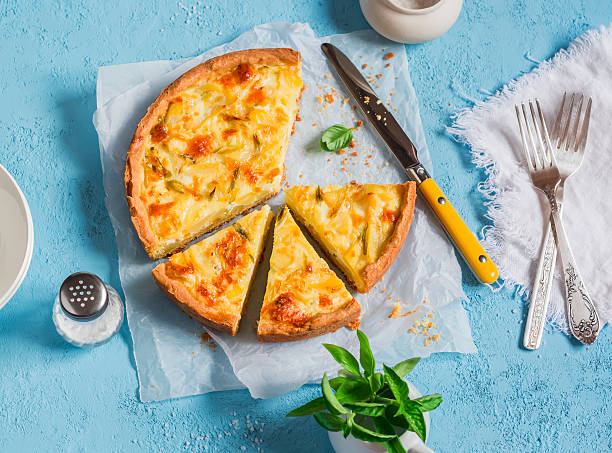 Leek, potato and cheese pie on a blue background Leek, potato and cheese pie on a blue background, top view. quiche stock pictures, royalty-free photos & images