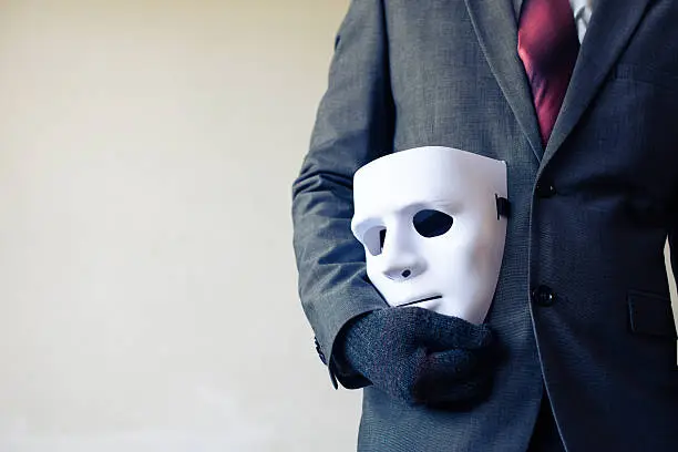 Photo of Businessman carrying white mask - business fraud and faking concept